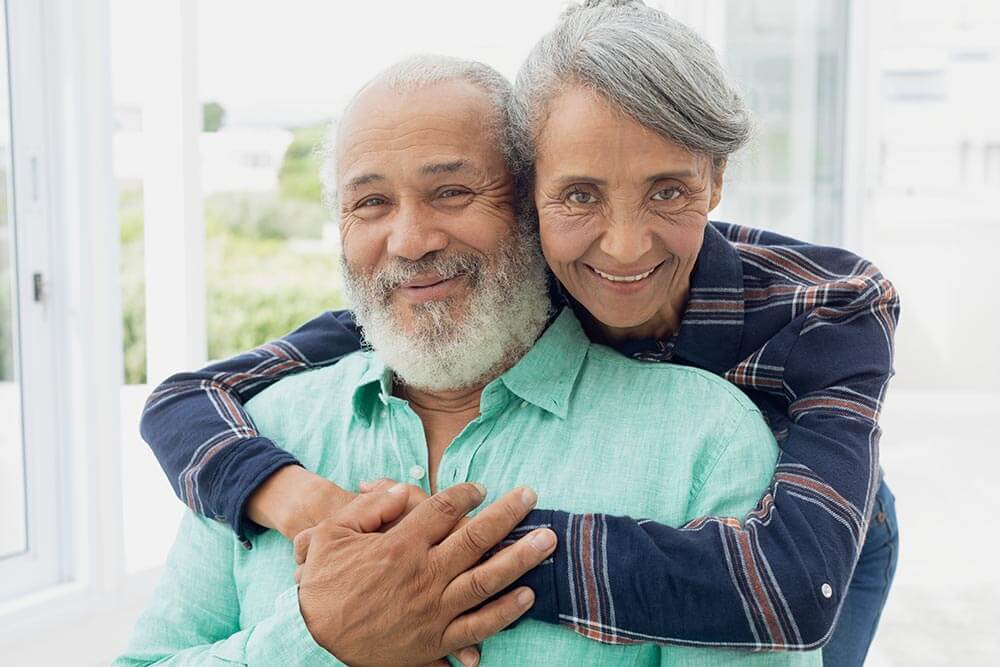 Couple embracing inside home